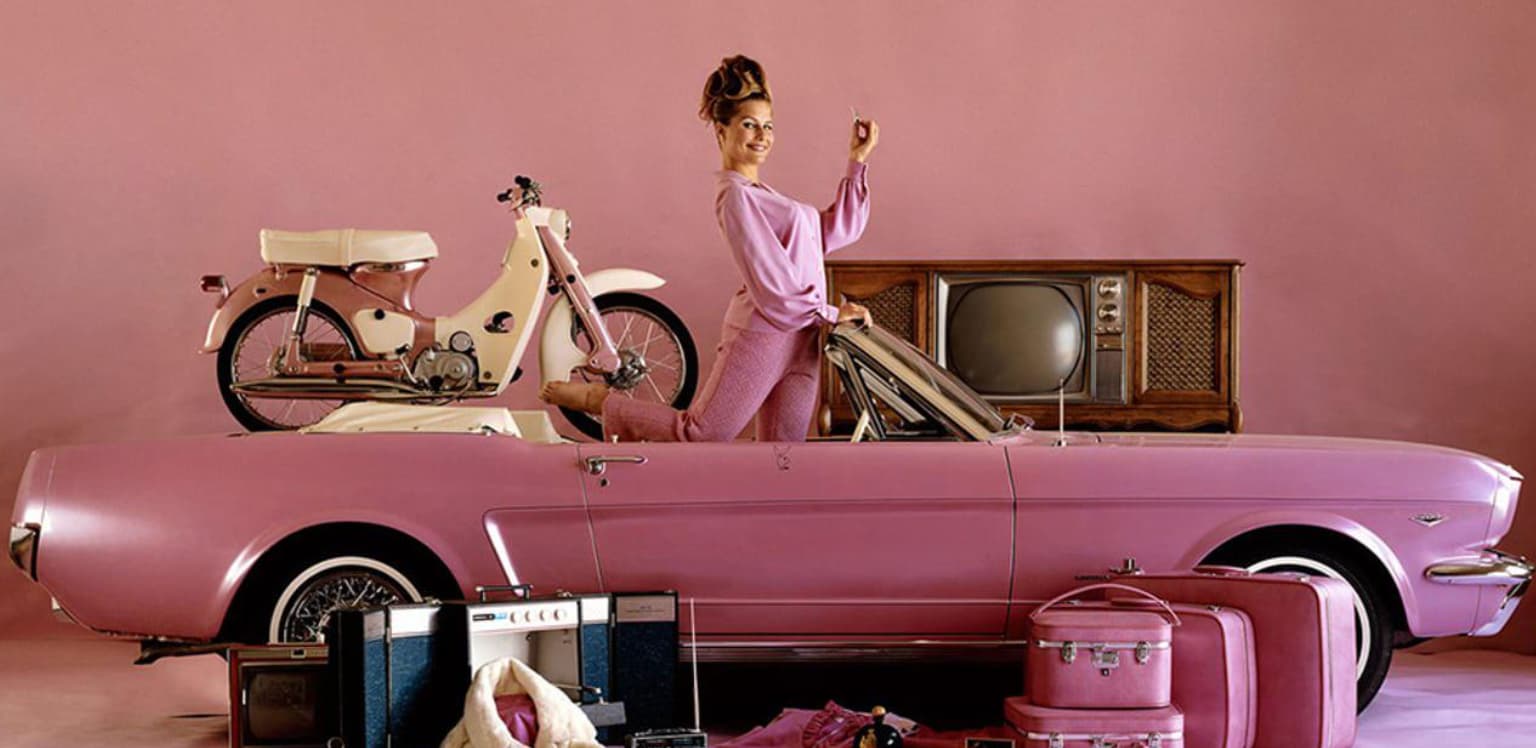 “Playmate of the Year for 1964 Donna Michelle with the prizes she was awarded, including a pink 1964 1/2 Ford Mustang convertible.”